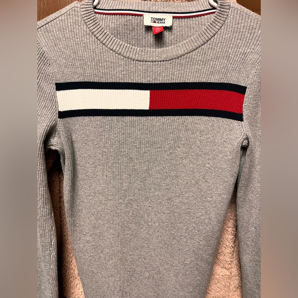 grey Tommy Jeans crewneck sweater featuring the brand's iconic flag design